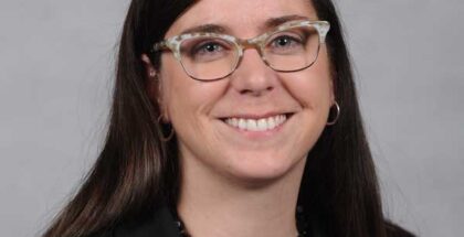 Profile picture of Megan Quinn (a caucasian woman similing at the camera while wearing glasses)