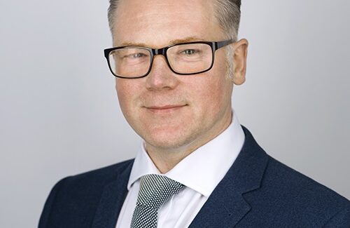 Headshot of Robert Thompson (a caucasian man wearing glasses and dressed in a suit with tie)