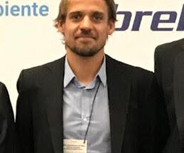 Profile picture of Thurben Knust - Man who is wearing a dark coloured suit along with a white tag hanging around the neck