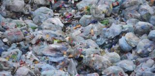 Image shows a large pile of garbage in bags