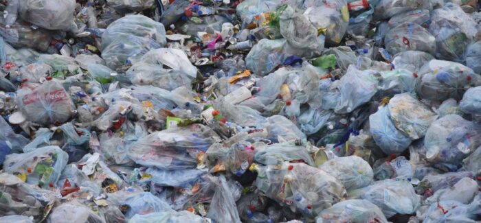 Image shows a large pile of garbage in bags